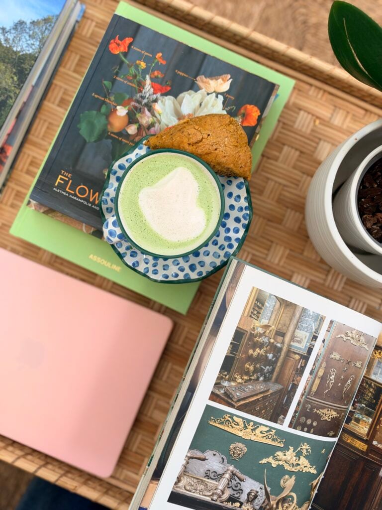 matcha tea in a tea cup with books and a laptop